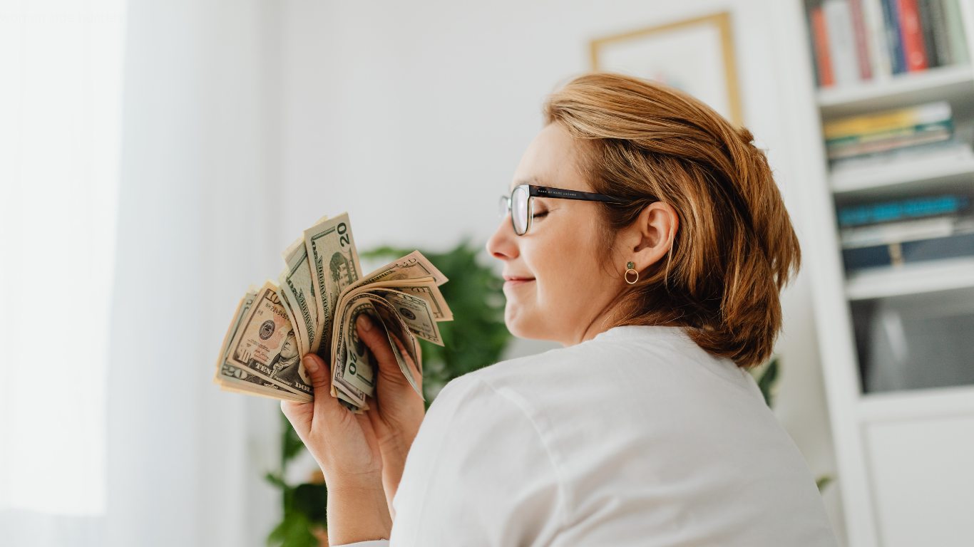 woman working from home on a laptop while exploring side hustles for women in 2026